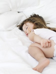 child sleeping in bed
