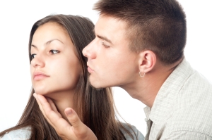 woman rejecting man's kiss