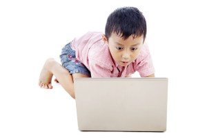 child playing with laptop