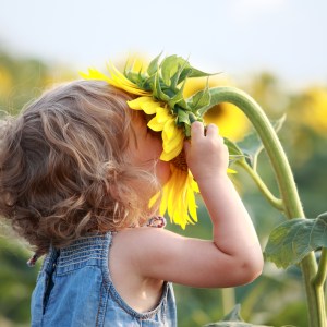 girl smelling a flower